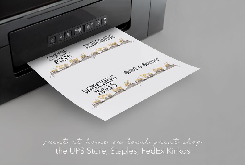 May include: A sheet of paper with a black and white illustration of construction vehicles and the text "Wrecking Balls", "Build-a-Burger", "Lemonade", and "Cheese Pizza". The paper is being printed from a black printer.