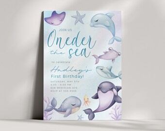 May include: A blue and purple invitation card with a watercolor illustration of sea creatures. The text reads "Join us Oneder the sea to celebrate Hadley's First Birthday! Saturday, May 5th 4:00 - 6:00 PM 628 Meridian Ave. RSVP at 555-5555".