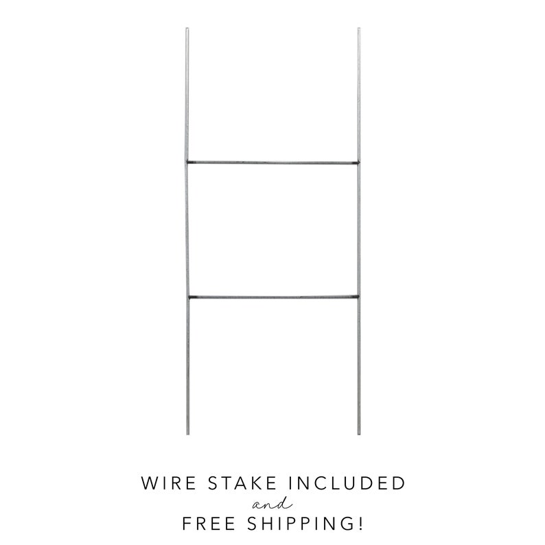 May include: A silver metal sign holder with two horizontal bars. The sign holder is designed to hold a sign or poster.  Wire stake included and free shipping!