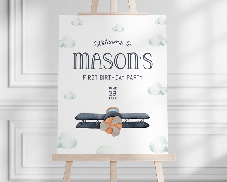 May include: Welcome to Mason's First Birthday Party sign with a blue airplane and white clouds on a white background. The date is June 23, 20XX.