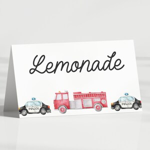 May include: A white card with the word "Lemonade" written in black cursive. There are three watercolor illustrations of vehicles: a red fire truck, and two black and white police cars.