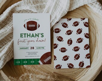 May include: A green and white invitation with a football design. The invitation reads "Ethan's first year down!" and includes the date "January 28" and time "6:00 PM".