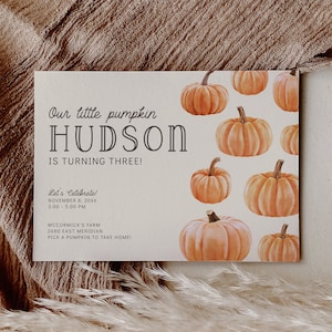 May include: A white card with a pumpkin theme for a birthday party. The card says "Our little pumpkin HUDSON is turning three!" and includes details for the party, including the date, time, location, and a request to pick a pumpkin to take home.
