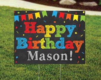 May include: A black chalkboard sign with colorful bunting and confetti. The sign says "Happy Birthday Mason!" in colorful, handwritten letters.