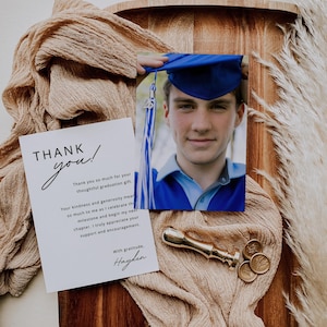 May include: A graduation thank you card with the words "THANK you!" in elegant script. The card is next to a photo of a graduate in a blue cap and gown, a brass wax seal, and decorative elements.