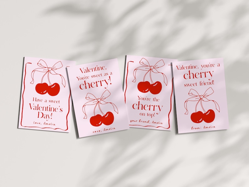May include: Four pink Valentine's Day cards with red cherry illustrations and text that reads "Have a sweet Valentine's Day! Love, Amelia", "Valentine, you're sweet as a cherry! xoxo, Amelia", "You're the cherry on top! Your friend, Amelia", and "Valentine, you're a cherry sweet friend! From: Amelia".