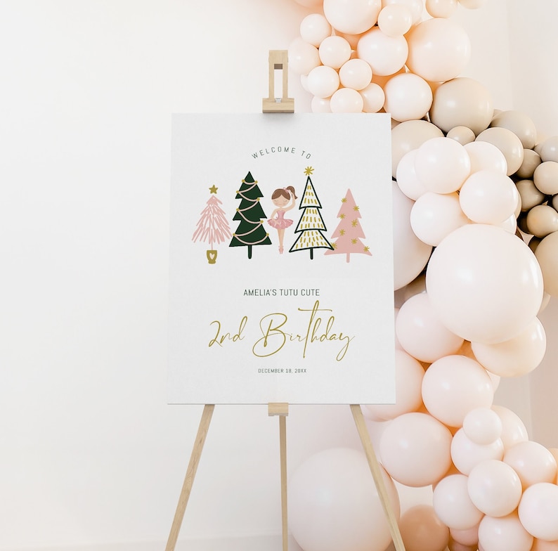 May include: Welcome to Amelia's Tutu Cute 2nd Birthday party sign with a ballerina and Christmas trees. The sign is on a wooden easel.