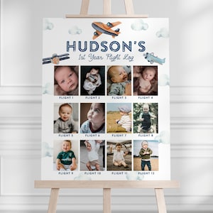 May include: A personalized "Hudson's 1st Year Flight Log" poster featuring a watercolor airplane design and cloud accents. The poster includes space for twelve photos, labeled "Flight 1" through "Flight 12", documenting a baby's first year.