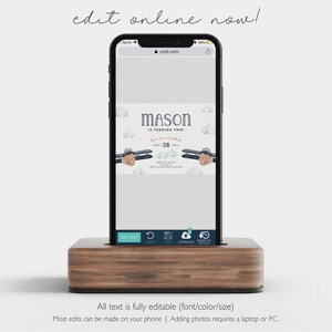 May include: A mobile phone displaying a digital invitation for a child's second birthday party. The invitation features a blue airplane with orange accents and the text "MASON IS TURNING TWO" with a date of "28".