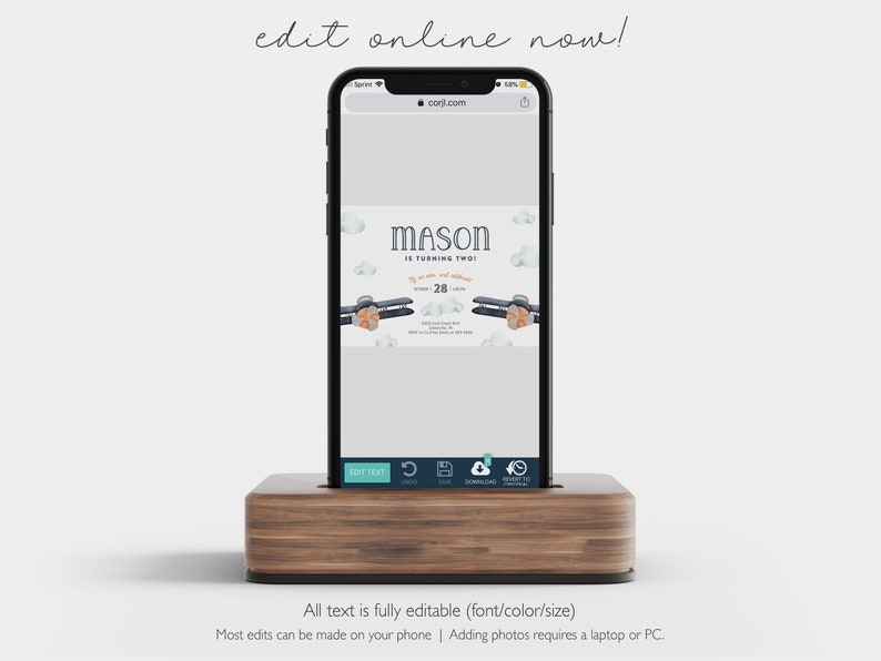 May include: A mobile phone displaying a digital invitation for a child's second birthday party. The invitation features a blue airplane with orange accents and the text "MASON IS TURNING TWO" with a date of "28".