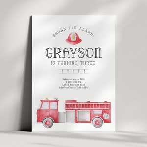 A birthday invitation with a red fire truck and a firefighter helmet. The text reads 'Sound the alarm! Grayson is turning three! Saturday, March 14th 3:00-5:00 PM 12546 Riverside Road RSVP to Emily at 555-5555'