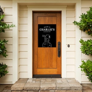 May include: A black and white welcome sign with the text "Welcome to Charlie's Space Station" and a cartoon astronaut standing on the moon.