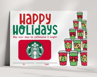 May include: A red and green gift card with the Starbucks logo and the text "Happy Holidays. May your days be caffeinated & bright!"  The card has a space for "To" and "From".  The card is decorated with a stack of coffee cups with Christmas-themed designs.