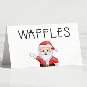 May include: A white card with the word "WAFFLES" written in black marker. A cartoon image of Santa Claus is in the bottom right corner of the card.