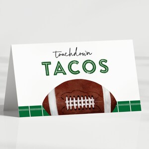 May include: White card with green text that says "touchdown TACOS" with a brown and white football on top of a green and white football field.