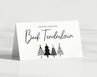 May include: A white card with black text that reads "Pepper-Crusted Beef Tenderloin". Four black and white stylized Christmas trees with copper stars are below the text.