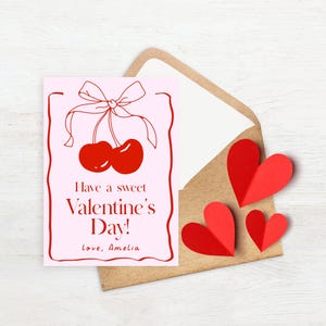 May include: A pink card with a red cherry illustration and the text "Have a sweet Valentine's Day! Love, Amelia."