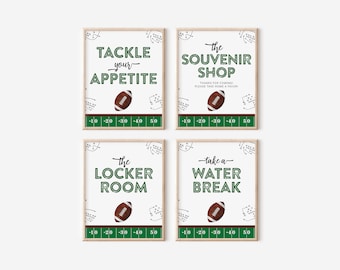 May include: Four printable signs with a football theme. The signs are white with black text and a football graphic. The text on the signs reads "Tackle Your Appetite", "The Souvenir Shop", "The Locker Room", and "Take a Water Break". Each sign has a green football field graphic at the bottom with yard lines marked from -10 to 50.