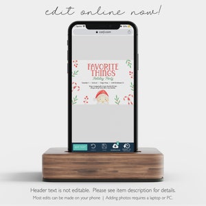 May include: A smartphone displaying a holiday party invitation with the text "FAVORITE THINGS Holiday Party." The invitation features festive illustrations of candy canes, holly, and Santa Claus. The phone rests in a wooden stand.