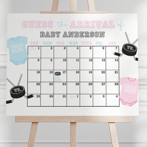May include: A white board with a calendar for the month of May. The calendar is decorated with hockey sticks and pucks. The text "Guess the Arrival of Baby Anderson" is at the top of the board. The calendar is for a baby shower game.