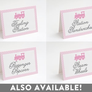 May include: Four pink and white striped signs with a pink train silhouette and text. The signs read "Fueling Station", "Station Sandwiches", "Passenger Popcorn", and "Steam Wheels".