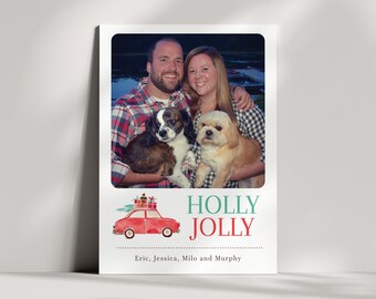 Puede incluir: Una tarjeta de Navidad con una foto de una pareja con dos perros. La tarjeta tiene un coche rojo con regalos en la parte superior y el texto "HOLLY JOLLY" en verde y rojo. Los nombres "Eric, Jessica, Milo y Murphy" están impresos debajo del coche.