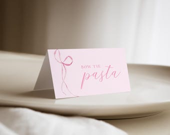 May include: Pink card with a pink ribbon design and the text "Bow Tie Pasta" written in cursive.