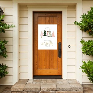 May include: A white door with a welcome sign for a 2nd birthday party. The sign features a girl in a pink tutu and a green and pink Christmas tree. The text on the sign reads "Welcome to [Name]'s 2nd Birthday".