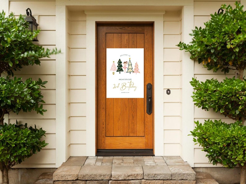 May include: A white door with a welcome sign for a 2nd birthday party. The sign features a girl in a pink tutu and a green and pink Christmas tree. The text on the sign reads "Welcome to [Name]'s 2nd Birthday".