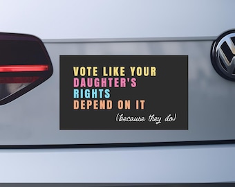 May include: A rectangular black magnet with the text "VOTE LIKE YOUR DAUGHTER'S RIGHTS DEPEND ON IT (because they do)" in yellow, pink, blue, and orange. The word "MAGNET" is printed in white at the bottom.