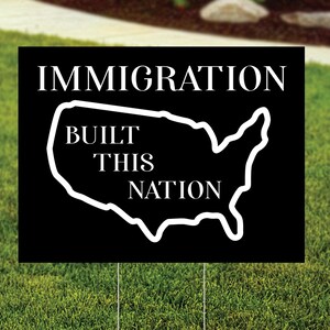 Immigration Built This Nation Yard Sign.  Black background with white graphic of USA.