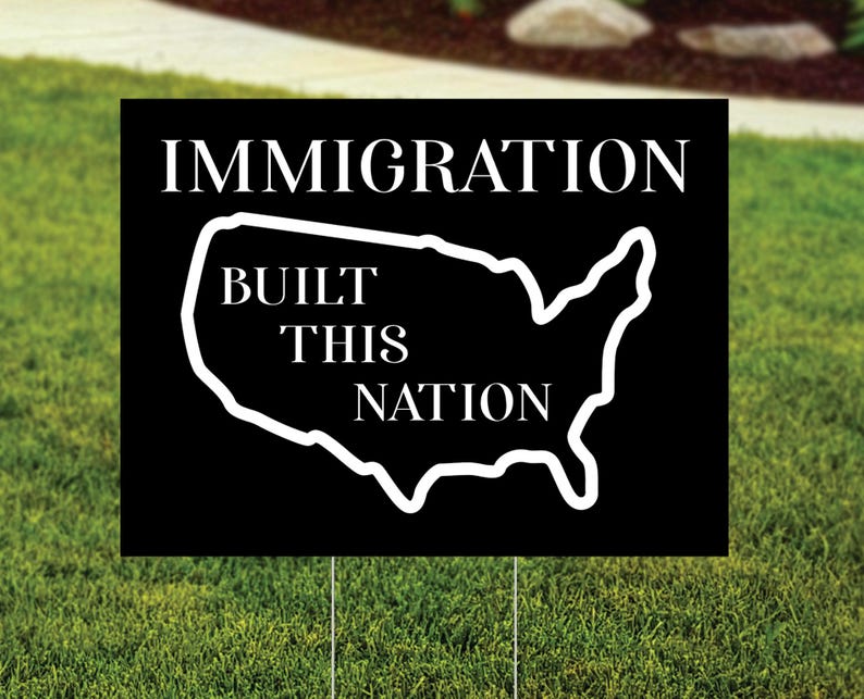 Immigration Built This Nation Yard Sign.  Black background with white graphic of USA.
