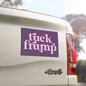 May include: A purple car magnet with the text "tuck frump" in pink lettering.