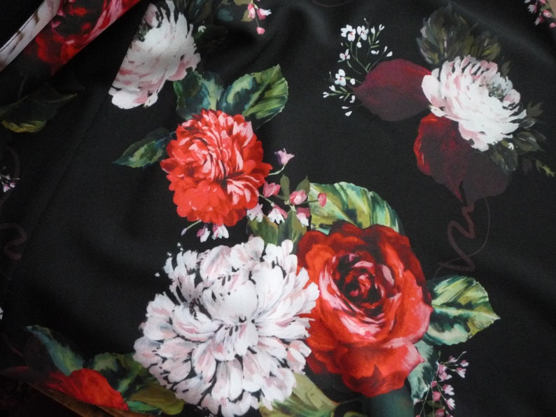 May include: Black fabric with a floral print featuring red, white, and burgundy roses, peonies, and small white flowers.