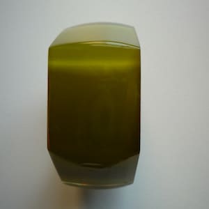 May include: A green glass bangle with a faceted design.
