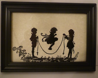 SILHOUETTES OF CHILDREN At Play. Wall Decor / Stand. Vintage Style Framed Silhouette Print Depicting Children At Play. Children Jump Roping.