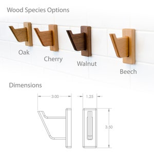 May include: Four wooden wall hooks in different wood species: oak, cherry, walnut, and beech. The hooks are 3 inches wide and 3.5 inches tall. The hooks are shown mounted on a white tiled wall.