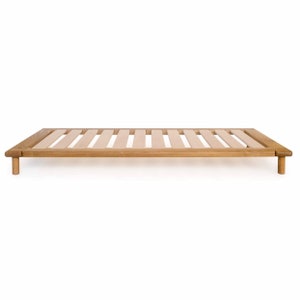 May include: A wooden bed frame with a slatted base and four legs. The frame is made of natural wood and has a light brown finish.