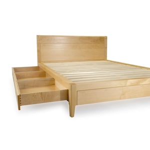 Peut inclure: Un cadre de lit plateforme en bois clair avec deux tiroirs qui sortent du c&ocirc;t&eacute;. Le cadre de lit a une base &agrave; lattes et une t&ecirc;te de lit simple.