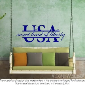 May include: A blue vinyl wall decal with the letters USA in a large font, with a double line underneath the letters. The text "sweet land of liberty" is written in a smaller font underneath the letters.
