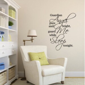 May include: A white armchair with a yellow pillow in a room with a white bookshelf. The wall behind the chair has a black vinyl decal that reads "Guardian Angel pure and bright, guard Me while I sleep tonight."