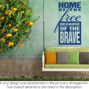May include: A blue vinyl wall decal with the text "Home of the free because of the brave". The decal is displayed on a green wall with a white swing hanging in front of it.