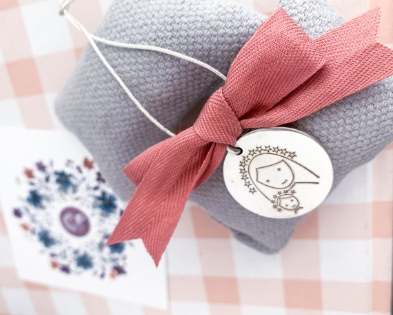 Sterling silver medallion for crib/cotton ribbon.