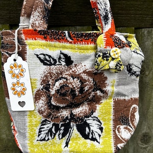handmade handbag made from vintage fabric lining brown fabric and a handmade flower on both sides
