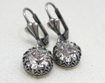 Sparkly Crystal Dangle Earrings with a Fleur de Lis design in the Antique Silver setting