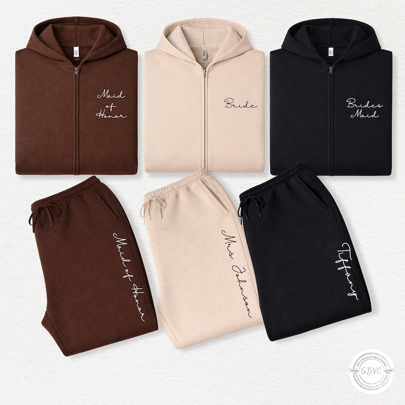 May include: A selection of matching zip-up hoodies and sweatpants in brown, beige, and black. The hoodies feature the words "Maid of Honor", "Bride", and "Brides Maid". The sweatpants have names embroidered on them.
