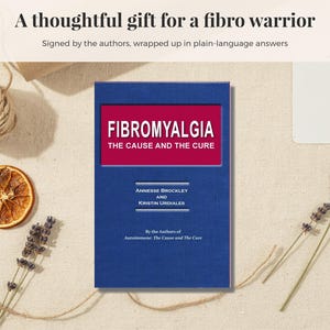 May include: A blue book titled Fibromyalgia The Cause and The Cure by Annesse Brockley and Kristin Urdiales. The cover features a red rectangular inset with white text. Above the book, the text reads A thoughtful gift for a fibro warrior.