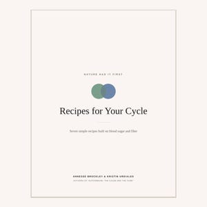 May include: A book cover with a cream background featuring the text "NATURE HAD IT FIRST" above two overlapping green and blue circles. Below this, the title "Recipes for Your Cycle" appears, followed by "Seven simple recipes built on blood sugar and fibre" and the authors "ANNESSE BROCKLEY & KRISTIN URDIALES" with "AUTHORS OF "AUTOIMMUNE: THE CAUSE AND THE CURE"" at the bottom.