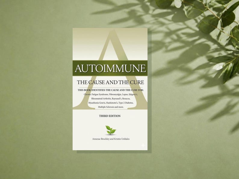 May include: A book titled Autoimmune: The Cause and The Cure, Third Edition, by Annesse Brockley and Kristin Urdiales. The cover features a large letter A, a green horizontal band, a small green plant icon, and a list of medical conditions.