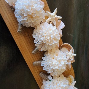 Set of 4 boutonnieres in cream and pale gold with shells and starfish